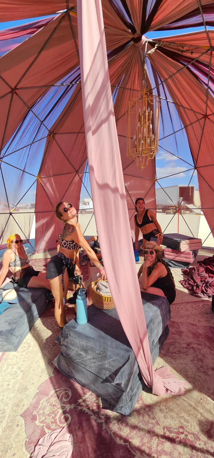 Pink silks and a chandelier inside the Muse dome